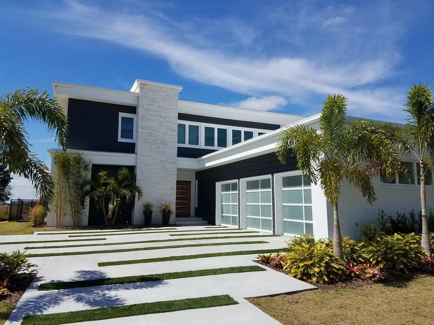 Modern two story home dark lap siding frosted glass garage doors, Sanford
